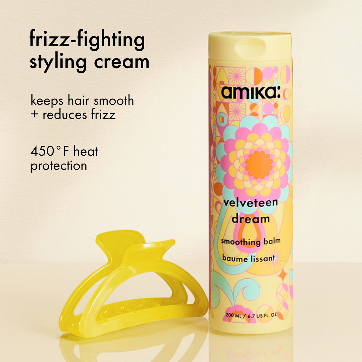 Amika velveteen dream smoothing balm with a yellow hair clip on a beige background