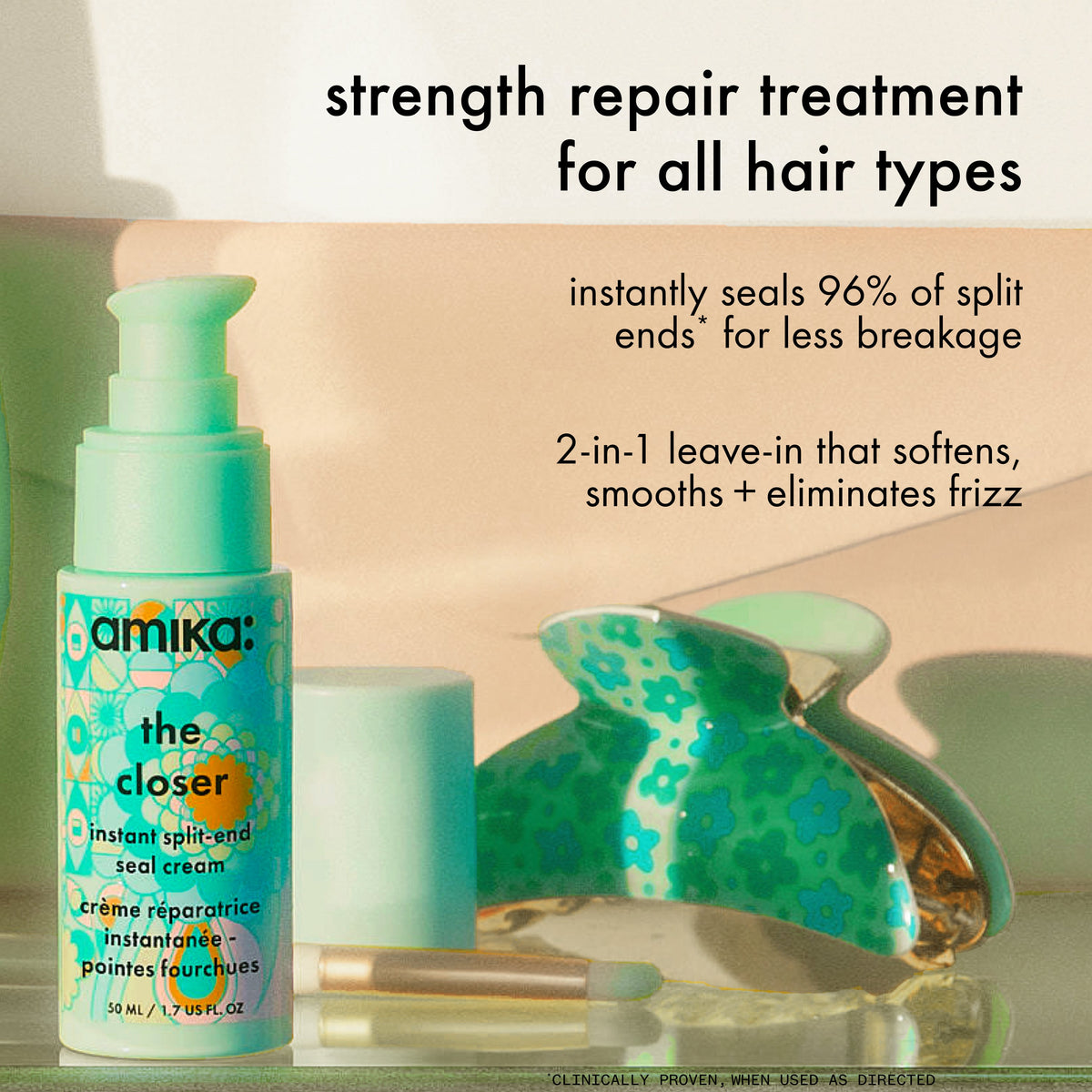 A bottle of Amika the closer sits on a counter with a green hair clip against a tan backgr