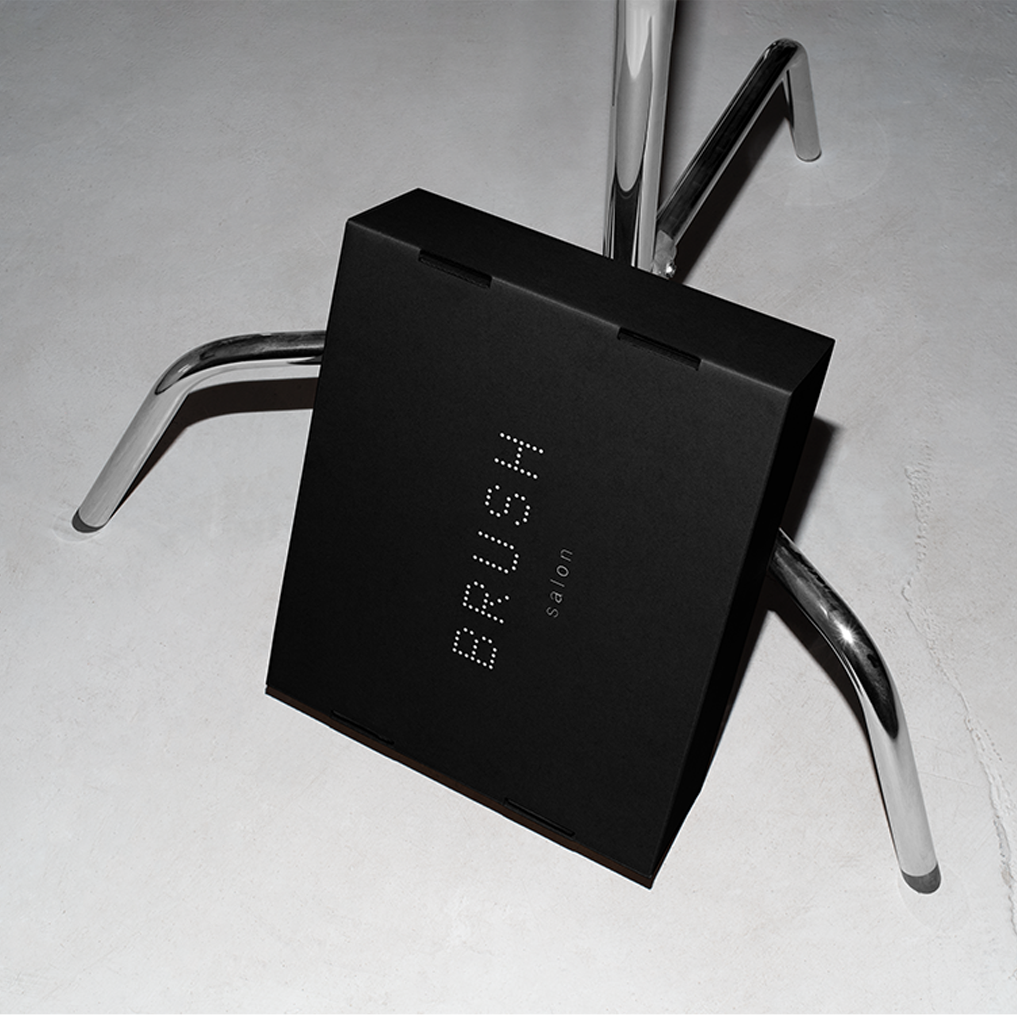 A black box labeled 'Shipping Protection' placed on a metal chair, symbolizing the coverage and protection offered by the product.