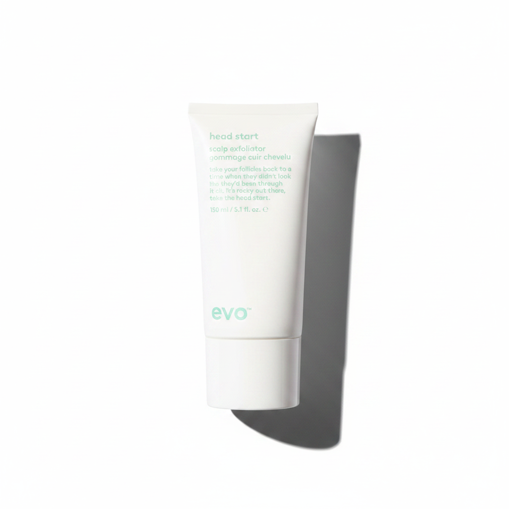 A white squeeze tube of evo Head Start Scalp Exfoliator on a solid white background.