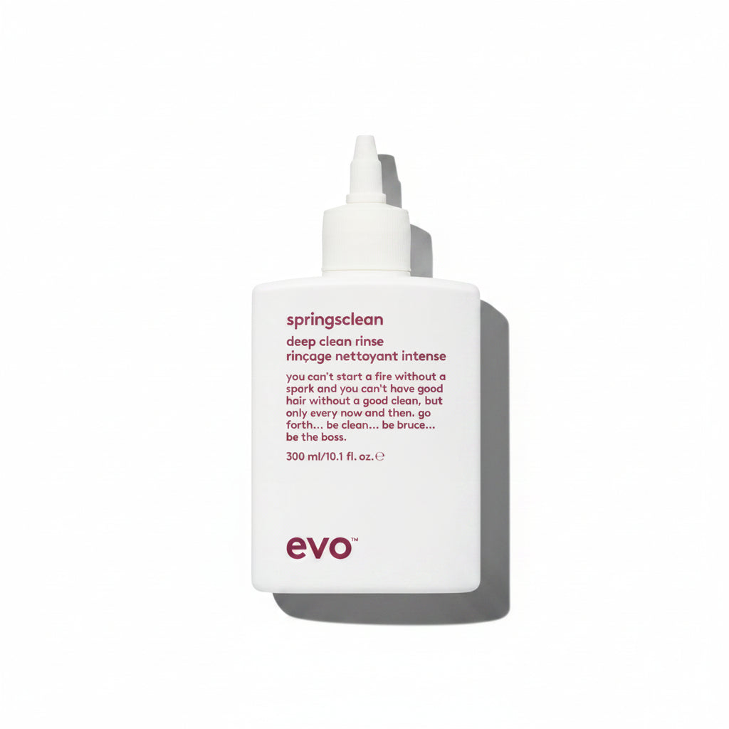 A white bottle with a pump dispenser labeled 'springsclean deep clean rinse' from the brand evo.