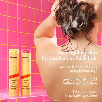Person washing hair with shampoo, featuring Amika 'forget frizz' products on a pink grid b