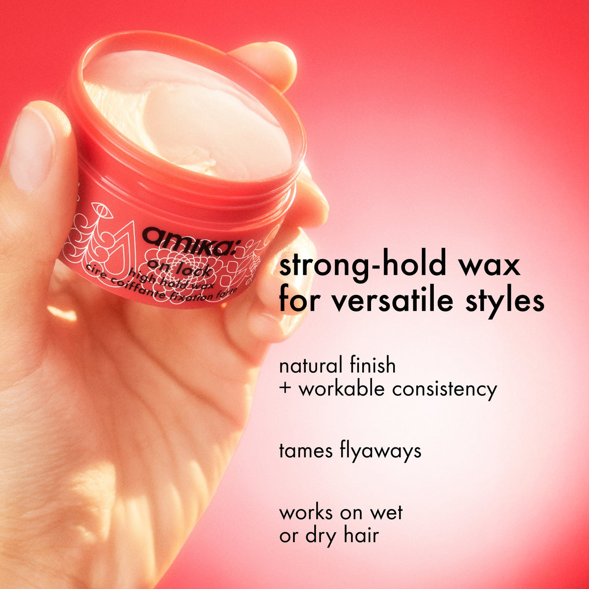 Amika strong-hold wax jar held by a hand with product description text on a pink backgroun