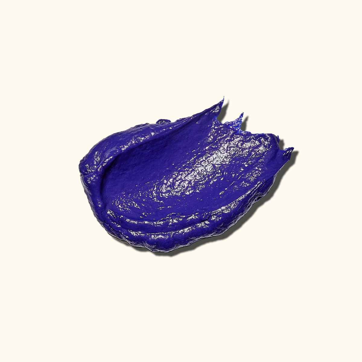 Texture image of the Amika bust your brass toning + strength repair mask for blonde + grey