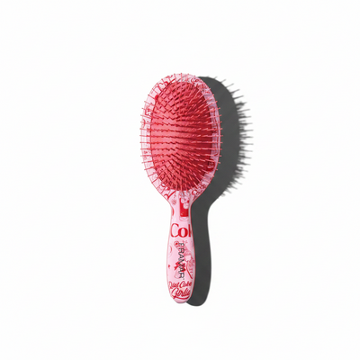 Pink hairbrush with lace design on a white background