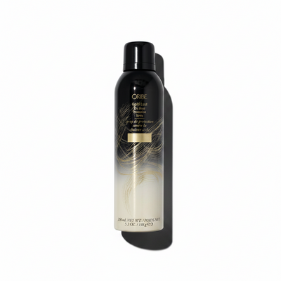 A spray bottle of Oribe Gold Lust Dry Heat Protection Spray