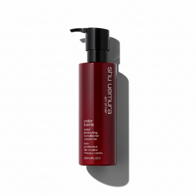 Red conditioner bottle with black pump on a white background