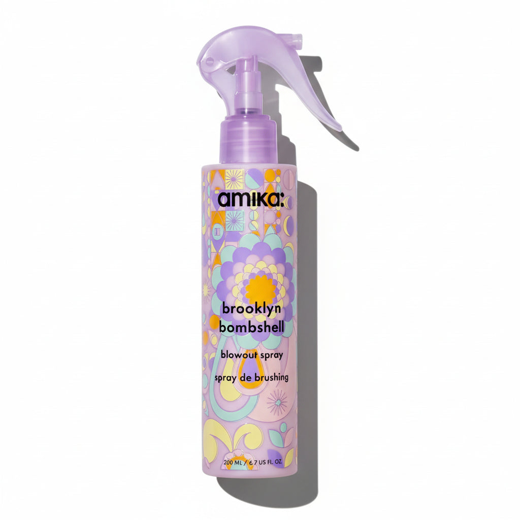 Amika Brooklyn Bombshell blowout spray bottle with floral design on a white background