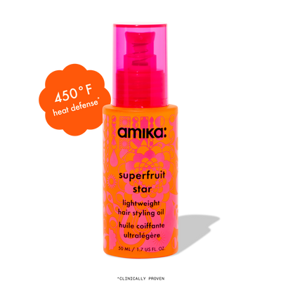 Amika Superfruit Star hair styling oil bottle with heat defense feature on a white backgro